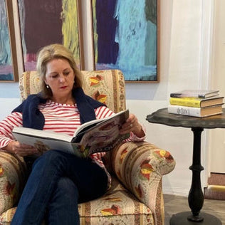Allison Bellinger reading a book in armchair