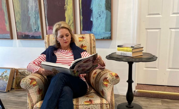 Allison Bellinger reading a book in armchair